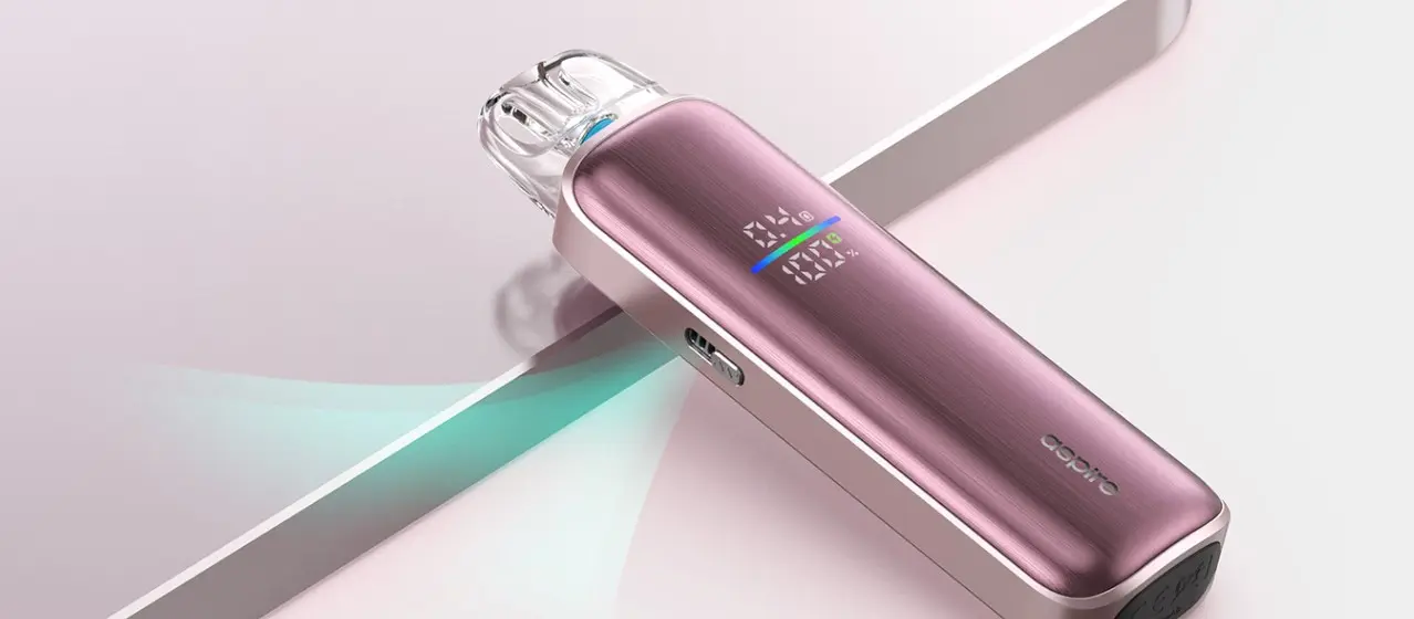 Pinkpurple vape pen with digital display resting on a pale surface showing settings and a color bar